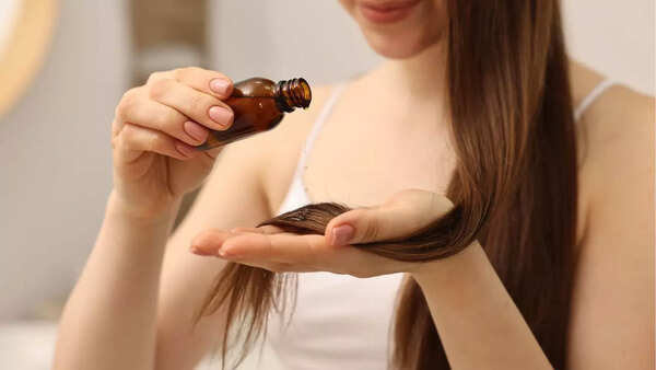 Person massaging hair oil into their scalp
