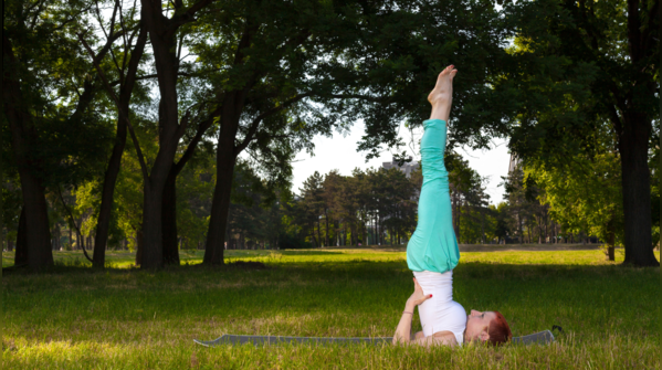 Demonstration of Sarvangasana, Shoulder Stand pose.